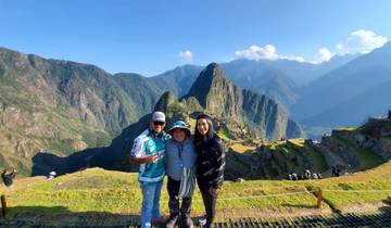 Group of people posing with Machu Picchu in the background.