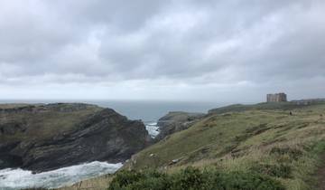 Coastal cliffs with a large building visible in the distance.