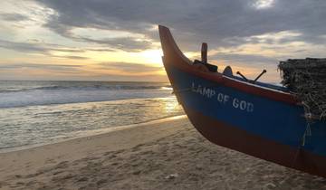 Boat on beach during a sunset with a visible inscription.