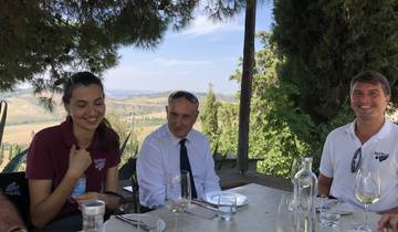 People dining outdoors with a scenic view in the background.