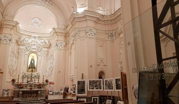Ornate church interior with religious icons and photographs.