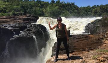 Person standing in front of Murchison Falls with a thumbs up.