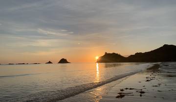 Beautiful sunset over the ocean with a reflection on the water.