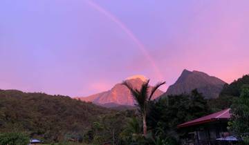 Mountain with a rainbow and sunset colors.