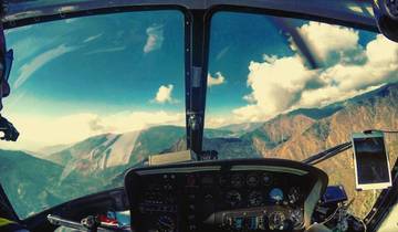 Interior view of a helicopter showing the landscape through windows.