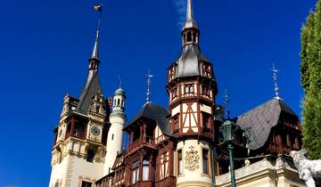 A grand castle with architectural details against a clear blue sky.