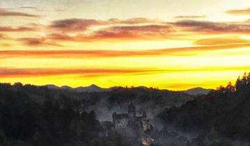 A castle silhouette against a vibrant sunset with colorful clouds.