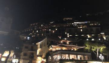 Hillside houses illuminated at night.