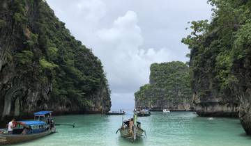 Narrow bay with boats surrounded by limestone cliffs.