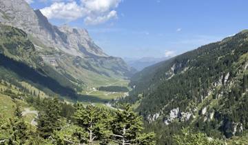 Scenic view of a valley with mountains and a clear sky.