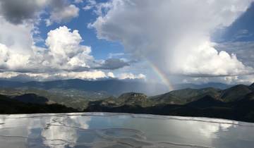 Stunning view of a landscape with a rainbow and mountains.