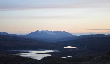 Snow-capped mountain range at sunrise