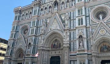 Ornate facade of the Florence Cathedral in a bustling square.