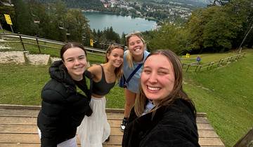 Group photo with a lake view and a small city in the distance.