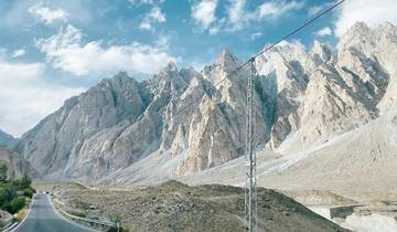 A scenic view of rugged mountains and road in Hunza Valley, Pakistan.