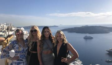 Group of friends posing with a stunning coastal view.