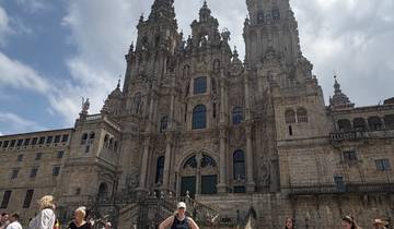 Tourists in front of a historic cathedral, likely in Santiago de Compostela.