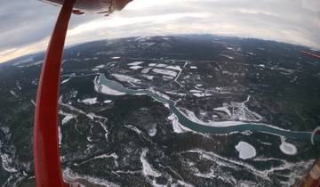 Aerial view of snowy landscape with rivers.