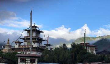 Traditional architecture in a lush mountainous landscape.