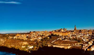 Panoramic view of a historic city with a prominent cathedral.