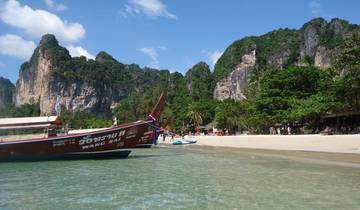 Traditional long-tail boat on a tropical beach.