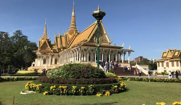A large ornate temple with visitors outside.