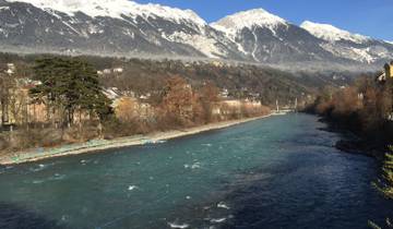 A tranquil river with a backdrop of snow-capped mountains.