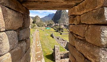 View through a stone structure towards Machu Picchu