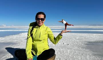 Person at Uyuni Salt Flats performing a perspective trick.