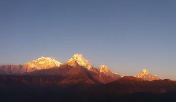 Series of mountains at sunset with warm hues.