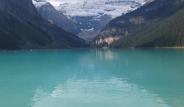 Blue lake with mountains and a glacier in the background.