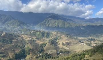 Panoramic view of terraced fields and mountains.
