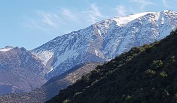 Snow-capped mountain peaks with clear blue sky.