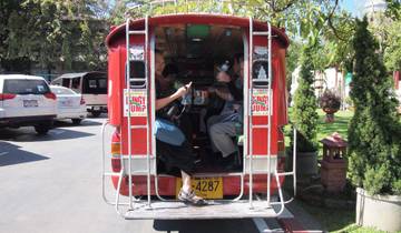 Tourists enjoying a ride in a red tuk-tuk