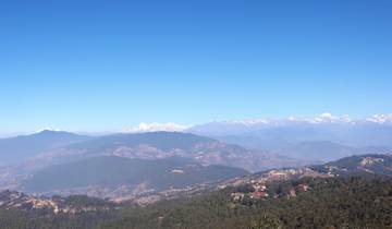 A wide mountain landscape with distant peaks.