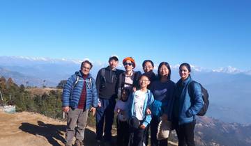 Family group posing with mountain view.