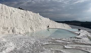 Bright white travertine terraces with pools of water.