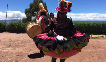 Colorfully dressed performers with drums outside.