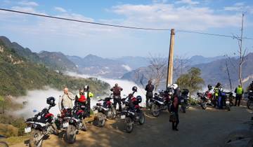 Group of motorcyclists with a mountain landscape in the background.