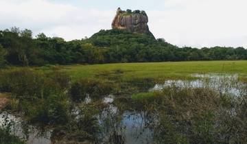 Dramatic rock formation rising from a landscape.