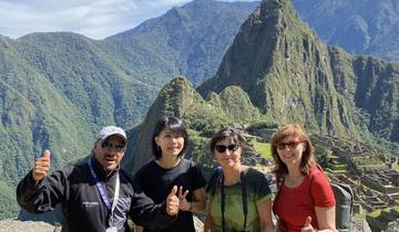 Group of people posing with Machu Picchu in the background.