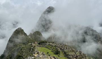 Machu Picchu surrounded by mist and clouds.