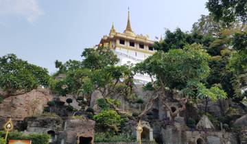 Temple atop a hill surrounded by lush greenery.