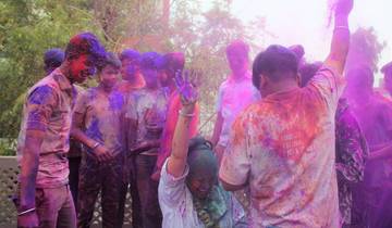 People celebrating Holi festival with colored powder.