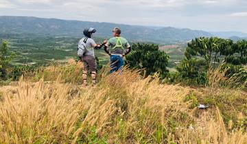 Two people looking out over terraced landscape.