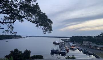 Harbor view with boats and a cloudy sky.
