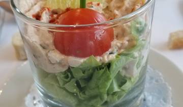 Gastronomic dish served in a glass with vegetables.