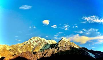 Snow-capped mountains under a deep blue sky.