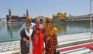 Family portrait in front of a golden temple.