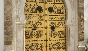 Ornate yellow and black patterned door within a stone building.
